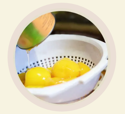 Convenience Canned peaches being poured into a strainer