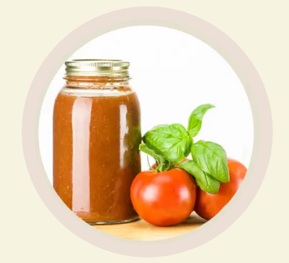 freshness Jar of tomato sauce with fresh tomatoes leaning against it